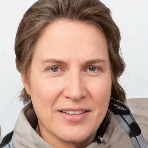 Joyful white adult female with short  brown hair and grey eyes