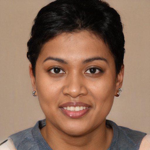 Joyful latino young-adult female with short  brown hair and brown eyes
