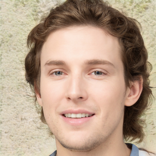 Joyful white young-adult male with medium  brown hair and blue eyes