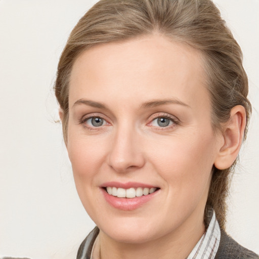 Joyful white young-adult female with medium  brown hair and blue eyes