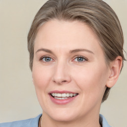 Joyful white adult female with medium  brown hair and grey eyes