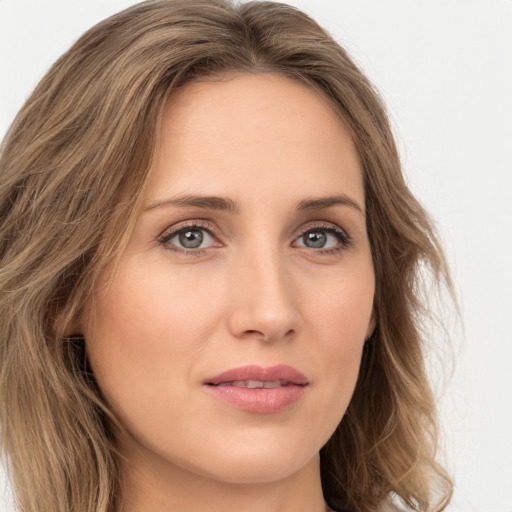 Joyful white young-adult female with long  brown hair and green eyes