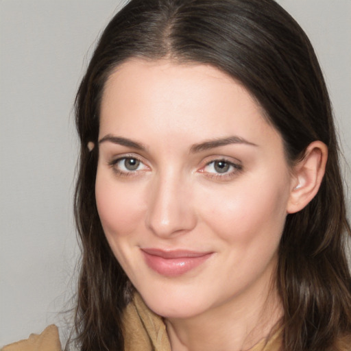 Joyful white young-adult female with long  brown hair and brown eyes