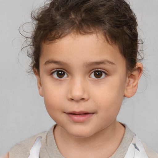 Joyful white child female with short  brown hair and brown eyes