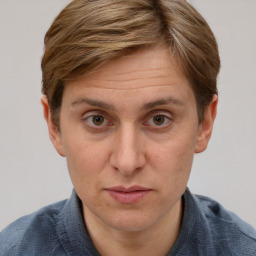 Joyful white adult female with short  brown hair and blue eyes