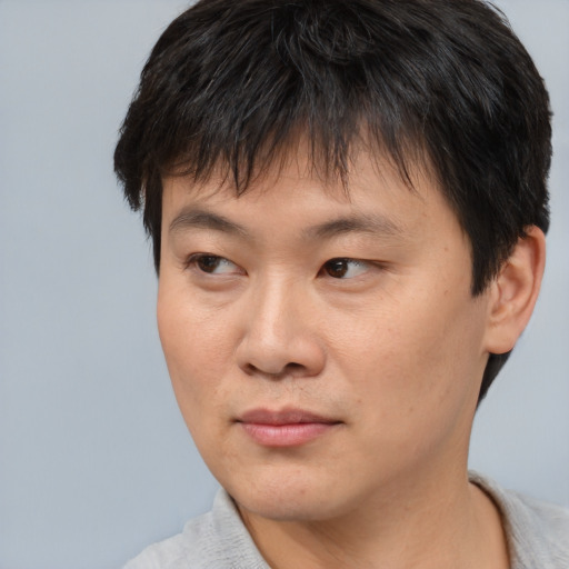 Neutral asian young-adult male with short  brown hair and brown eyes