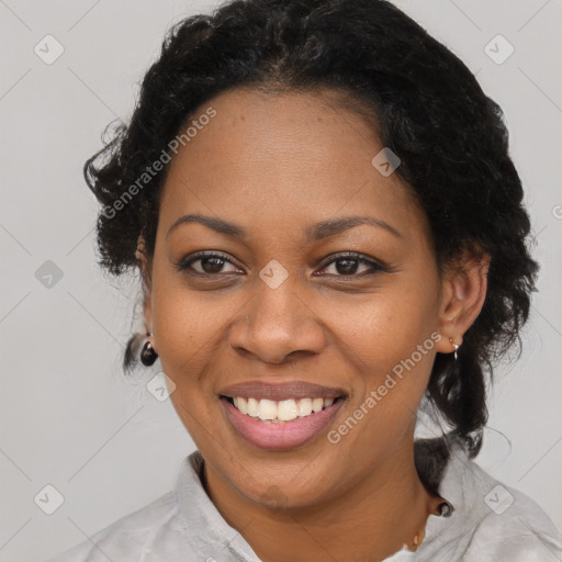 Joyful black adult female with short  brown hair and brown eyes