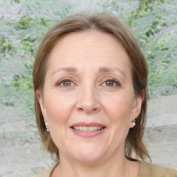 Joyful white adult female with medium  brown hair and blue eyes