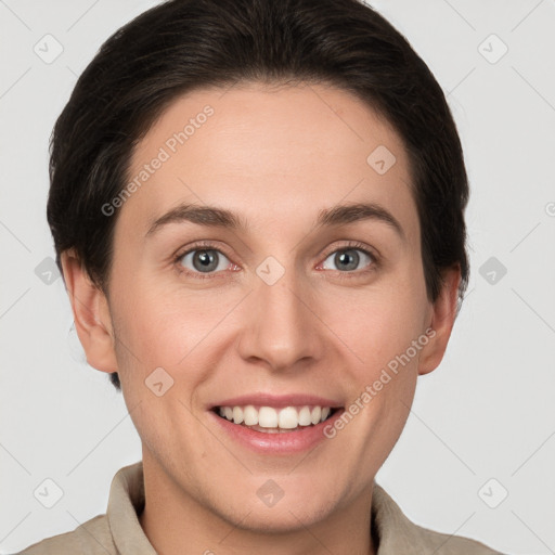 Joyful white young-adult female with short  brown hair and grey eyes