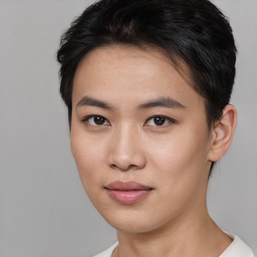 Joyful asian young-adult female with short  brown hair and brown eyes