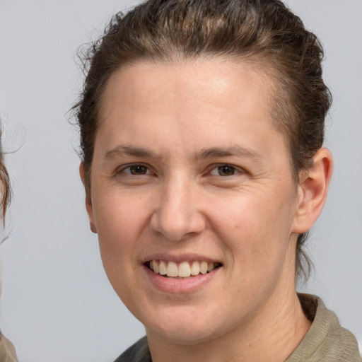 Joyful white adult female with medium  brown hair and grey eyes