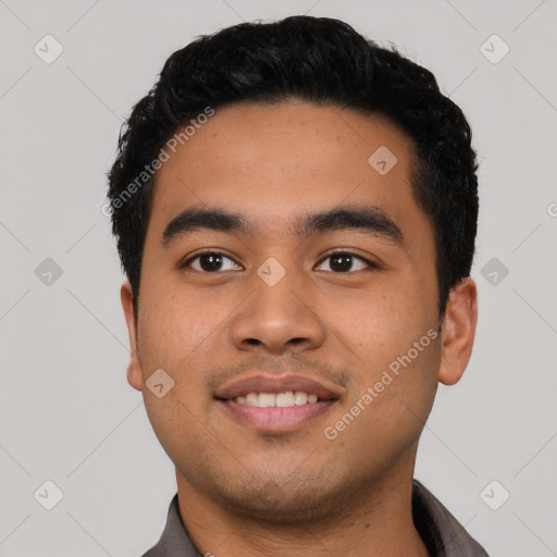 Joyful latino young-adult male with short  black hair and brown eyes