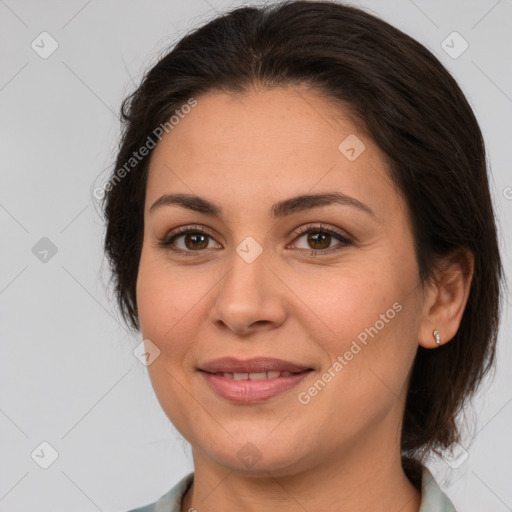 Joyful white adult female with medium  brown hair and brown eyes