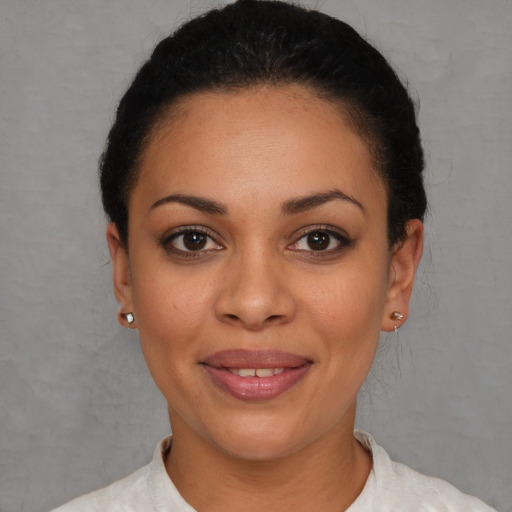 Joyful latino young-adult female with short  brown hair and brown eyes