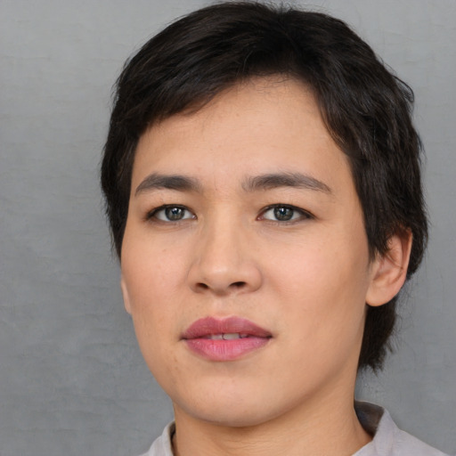 Joyful asian young-adult female with medium  black hair and brown eyes