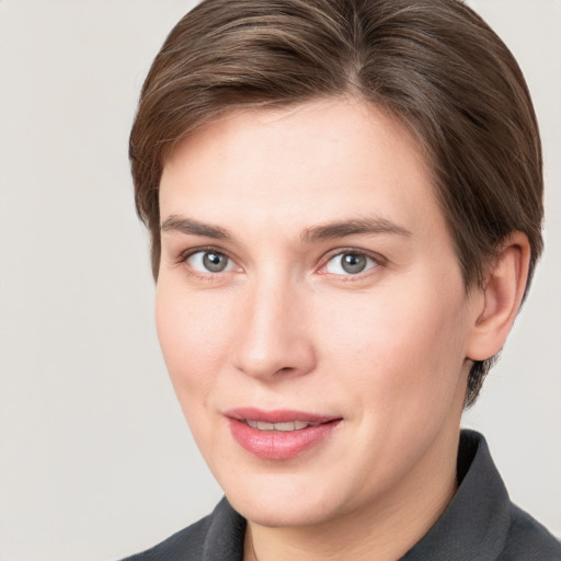 Joyful white young-adult female with short  brown hair and grey eyes