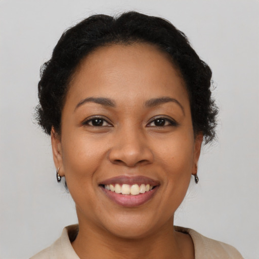 Joyful latino young-adult female with short  brown hair and brown eyes