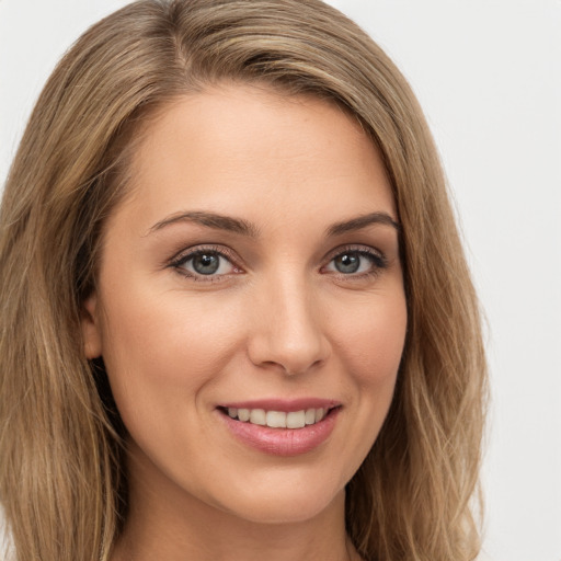 Joyful white young-adult female with long  brown hair and green eyes