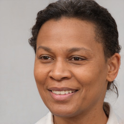 Joyful black adult female with short  brown hair and brown eyes