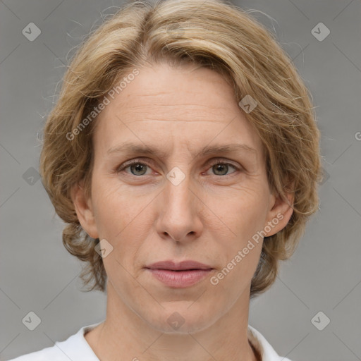 Joyful white adult female with medium  brown hair and grey eyes