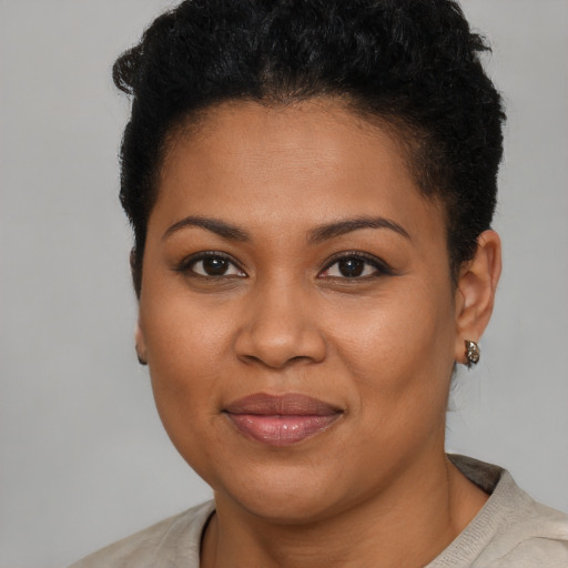 Joyful black young-adult female with short  brown hair and brown eyes