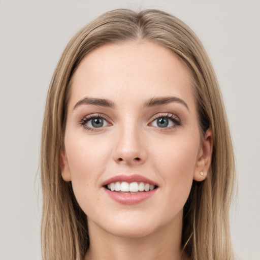 Joyful white young-adult female with long  brown hair and grey eyes