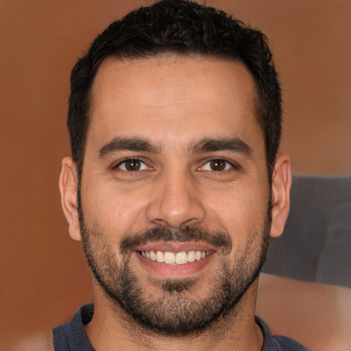 Joyful white young-adult male with short  black hair and brown eyes