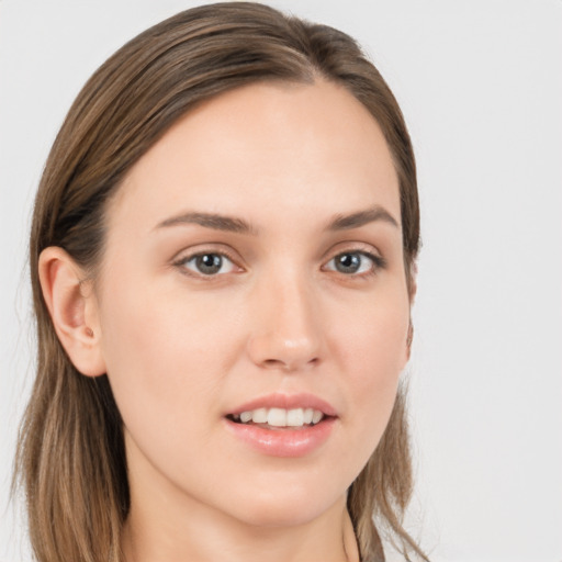 Joyful white young-adult female with long  brown hair and grey eyes