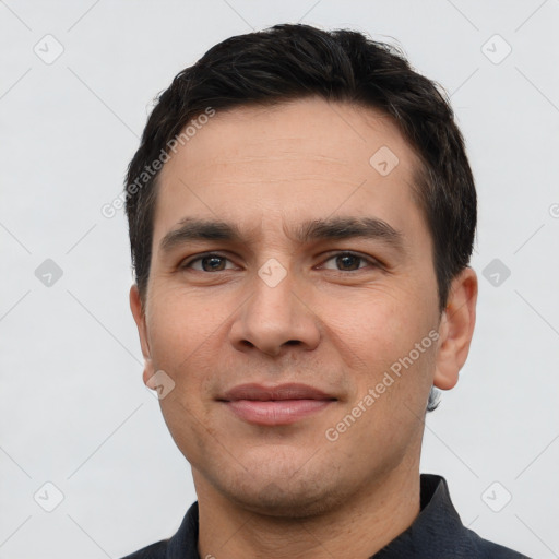 Joyful white young-adult male with short  black hair and brown eyes