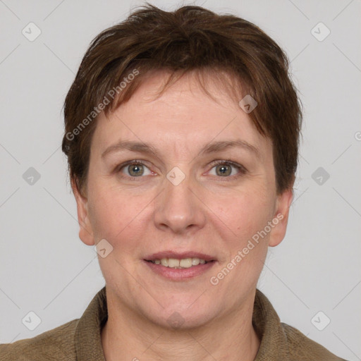 Joyful white adult female with short  brown hair and grey eyes