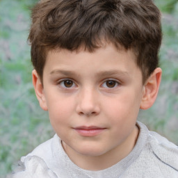 Joyful white child male with short  brown hair and brown eyes