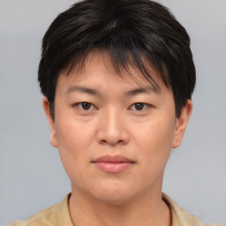 Joyful asian young-adult female with short  brown hair and brown eyes