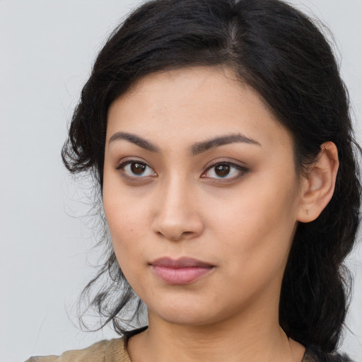 Neutral latino young-adult female with long  brown hair and brown eyes