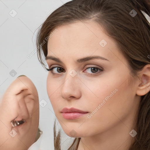 Neutral white young-adult female with long  brown hair and brown eyes