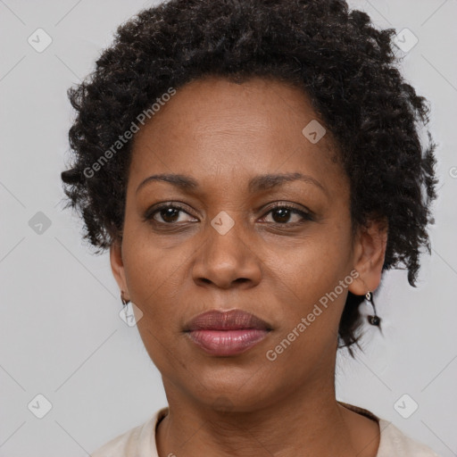 Joyful black adult female with short  brown hair and brown eyes