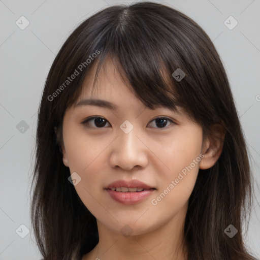 Joyful asian young-adult female with long  brown hair and brown eyes