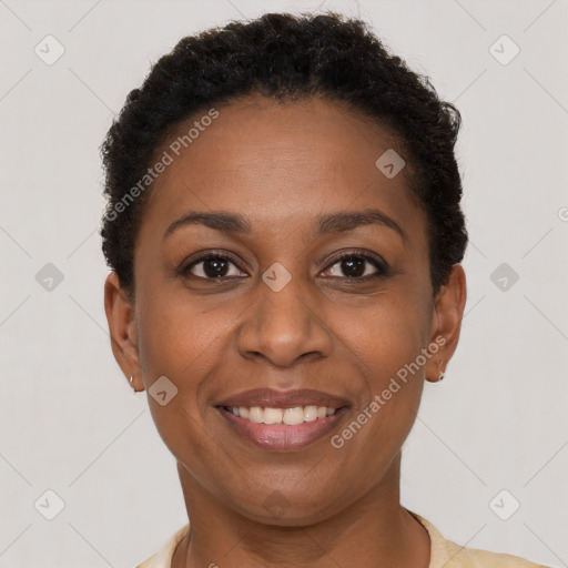 Joyful black adult female with short  brown hair and brown eyes