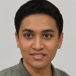 Joyful latino young-adult male with short  black hair and brown eyes