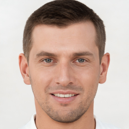 Joyful white young-adult male with short  brown hair and brown eyes