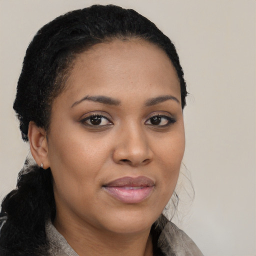 Joyful black young-adult female with medium  brown hair and brown eyes