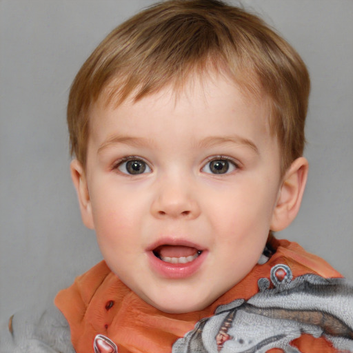 Joyful white child male with short  brown hair and blue eyes