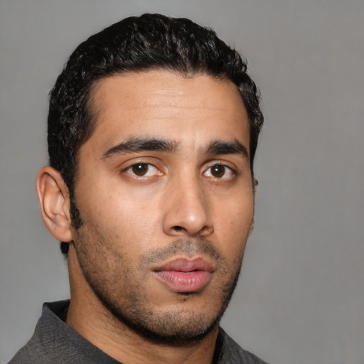 Neutral latino young-adult male with short  black hair and brown eyes