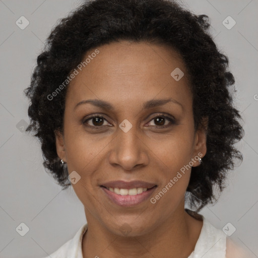 Joyful black adult female with short  brown hair and brown eyes