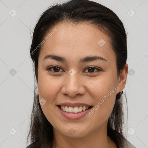 Joyful asian young-adult female with long  brown hair and brown eyes