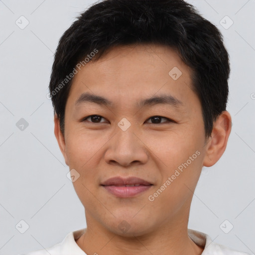 Joyful asian young-adult male with short  brown hair and brown eyes