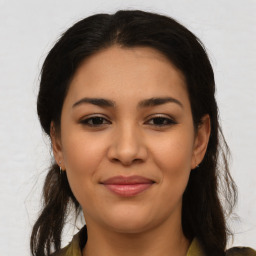 Joyful latino young-adult female with medium  brown hair and brown eyes