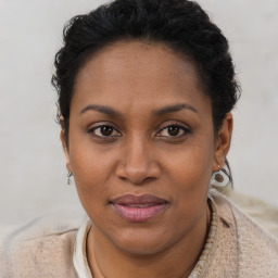 Joyful black adult female with short  brown hair and brown eyes