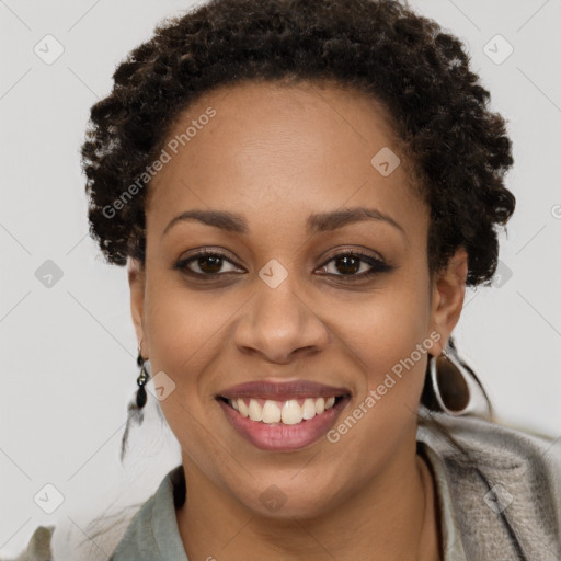 Joyful black young-adult female with short  brown hair and brown eyes