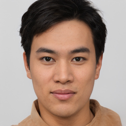 Joyful asian young-adult male with short  brown hair and brown eyes