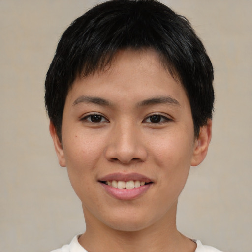 Joyful asian young-adult female with short  brown hair and brown eyes